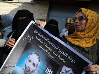 Palestinians take part in a protest in solidarity with Palestinian prisoners on hunger strike in Israeli jails, on November 22, 2021 in Gaza...