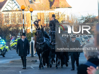  Members of the public align the streets outside Southend West Conservative Association's Iveagh Hall to pay their respects as a horse-drawn...