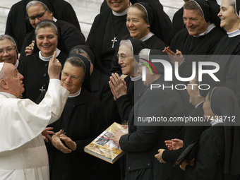 Pope Francis poses for as photo with a group of nuns at the end of his weekly general audience in the Paul VI Hall the Vatican, Wednesday, N...