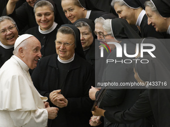 Pope Francis poses for as photo with a group of nuns at the end of his weekly general audience in the Paul VI Hall the Vatican, Wednesday, N...