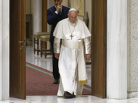 Pope Francis arrives in the Paul VI Hall for his weekly general audience at the Vatican, Wednesday, Nov. 24, 2021.  (