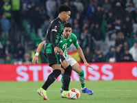 Ryan Mmaee of Ferencarosi TC in action with Marc Bartra of Real Betis during the UEFA Europa League Group G stage match between Real Betis a...