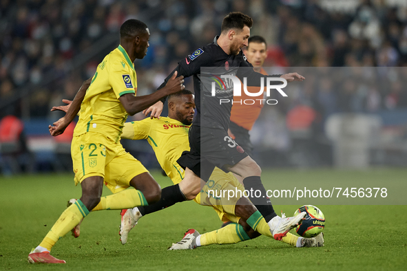 Leo Messi of PSG and Randal Kolo Muani of Nantes compete for the ball during the Ligue 1 Uber Eats match between Paris Saint Germain and FC...
