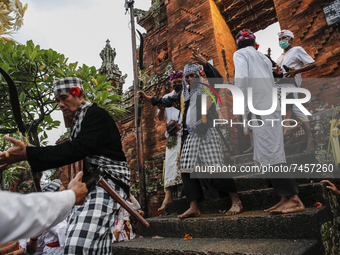 Balinese Hindu devotees in trance during the sacred ritual of Ngerebong amid COVID-19 pandemic in Kesiman Village, Denpasar, Bali, Indonesia...
