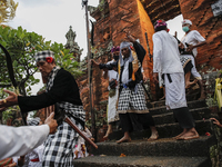 Balinese Hindu devotees in trance during the sacred ritual of Ngerebong amid COVID-19 pandemic in Kesiman Village, Denpasar, Bali, Indonesia...