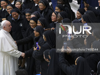 Pope Francis is cheered by nuns at the end of his weekly general audience in the Paul VI Hall at the Vatican, Wednesday, Dec. 1, 2021.  (