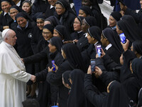 Pope Francis is cheered by nuns at the end of his weekly general audience in the Paul VI Hall at the Vatican, Wednesday, Dec. 1, 2021.  (
