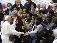 Pope Francis poses for photos with participants into his weekly general audience in the Paul VI Hall at the Vatican, Wednesday, Dec. 1, 2021...
