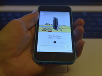 An iPhone displaying the track screen, which gives information about the currently playing tune, of the Beats 1 radio station, to a listener...