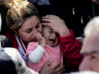 A child cries on her mother's arms waiting to cross the Greek-Macedonian border. Gevgelija, August 23, 2015. (Photo by Kostis Ntantamis/NurP...
