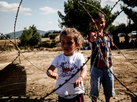 A girl and a boy at the Greek-Macedonian border. Idomeni, August 23, 2015. (Photo by Kostis Ntantamis/NurPhoto)