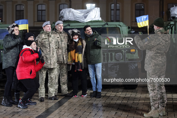 Ukrainian servicemen pose for a photo before an official ceremony to hand over of 13 'High Mobility Multipurpose Wheeled Vehicle' (HMMWV, ak...