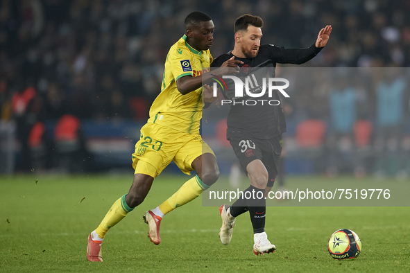 Leo Messi of PSG and Randal Kolo Muani of Nantes compete for the ball during the Ligue 1 Uber Eats match between Paris Saint Germain and FC...