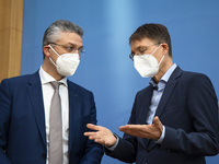 German Health Minister Karl Lauterbach (R) and President of Robert Koch Intitute Lothar Wieler (L) arrive to a press conference regarding ch...