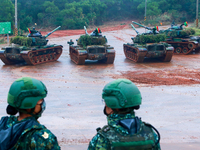 Soldiers stand guard as tanks are deployed during  a live ammunition military drill at an unnamed  location, amid rising tensions with China...