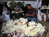 A Palestinian farmer prepares roses for sale ahead of the New Year, in the southern Gaza Strip,on December 29, 2021. 
 (