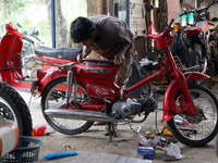 Workers replace antique motorcycle parts which are being restored at the old Motor Gallery in Pondok Cabe, Tangerang, December 29, 2021. The...