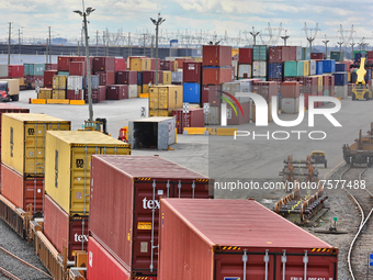 Intermodal shipping containers are unloaded from trains and stacked and loaded on trucks for transport at a cargo facility in Mississauga, O...
