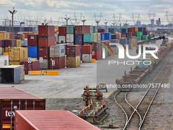 Intermodal shipping containers are unloaded from trains and stacked and loaded on trucks for transport at a cargo facility in Mississauga, O...