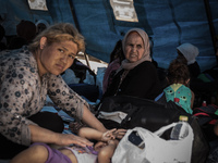 A woman inside a tent for refugee in Gevgelija, on August 26, 2015. The EU is grappling with an unprecedented influx of people fleeing war,...