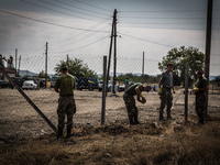 Macedonian forces install new fence around the camp and electricity, near the Macedonian town of Gevgelija, on August 26, 2015. The EU is gr...