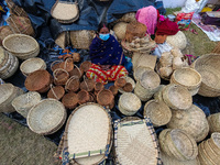 A lady is seen selling hand woven bamboo baskets at a handicraft fair in Kolkata , India , on 31 December 2021 . (
