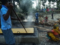 Workers boiling sugarcane juice as they are making Gur (jaggery) in a village on December 10, 2021 in Barpeta, Assam, India. Gur (jaggery) i...