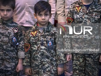 Iranian young boys in military uniforms wearing portraits of the Iranian top IRGC commander, General Qasem Soleimani who was killed in a U.S...