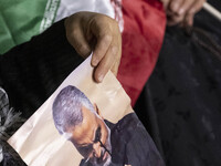 Iranian veiled women hold an Iran flag and a portrait of the Iranian top IRGC commander, General Qasem Soleimani who was killed in a U.S. dr...