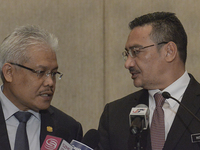 Malaysian Transport Minister Hishammuddin Hussein (R) speaks with Deputy Minister of Foreign Affair,Hamzah Zainuddin during a press conferen...