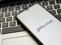 In this photo illustration a Micron logo seen displayed on a smartphone screen with a computer keyword in the background in Athens, Greece o...