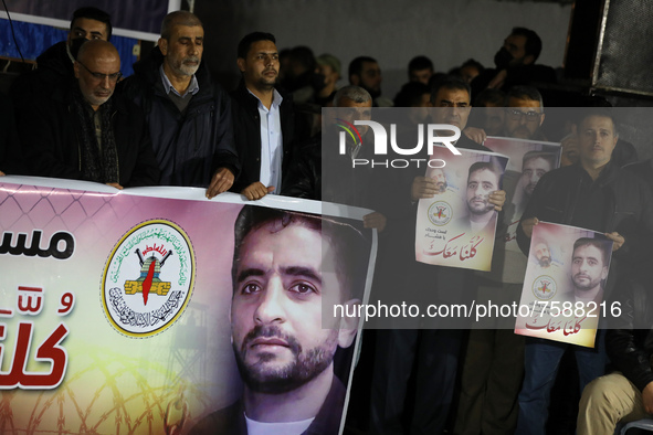  Palestinian protesters hold pictures of Hisham Abu Hawash, 40, who has been on a hunger strike for more than 140 days after he was arrested...