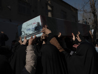 Iranian veiled women carrying a coffin containing remaining of a body of an Iranian warrior who has been killed during the Iran-Iraq war, wh...