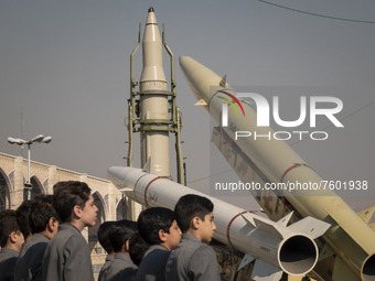 Iranian schoolboys perform as the Iranian Qiam short-range surface-to-surface ballistic missile (C), Solid-propelled road-mobile single-stag...