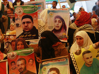 Palestinians take part in a protest demanding the release of their relatives prisoners held in Israeli jails, in front of the Red Cross offi...