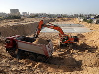 Egyptian machinery work at the construction site of a new housing complex north of Gaza City on January 11, 2022. - Egypt is making its pres...
