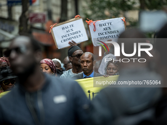 People on September 4, 2015 in Paris during a rally in tribute to the victims of a fire in an apartment building in the Myrha street, northe...