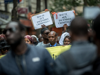 People on September 4, 2015 in Paris during a rally in tribute to the victims of a fire in an apartment building in the Myrha street, northe...