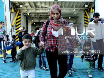 Families of Syrian refugees and migrants from Asia disembark in the port of Piraeus, near Athens, on September 5, 2015.  The chartered by th...