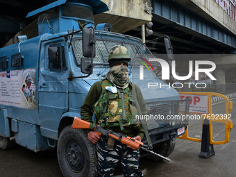 Indian forces stand near a barricade during restrictions outside the venue of India's Republic Day in Srinagar, Indian Administered Kashmir...