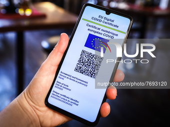 EU Digital COVID Certificate is displayed on a mobile phone screen photographed inside a restaurant for illustration photo during the spread...
