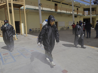 Workers sanitise the facilities of the Cristóbal Colón Primary School in Xochimilco, Mexico City, following the increase in COVID-19 infecti...