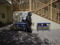 A worker sanitises the facilities of the Cristóbal Colón Primary School in Xochimilco, Mexico City, following the increase in COVID-19 infec...