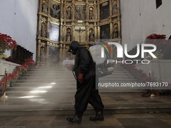 A worker sanitises the interior of the Cathedral of San Bernardino de Siena in Xochimilco, Mexico City, following the increase in COVID-19 i...