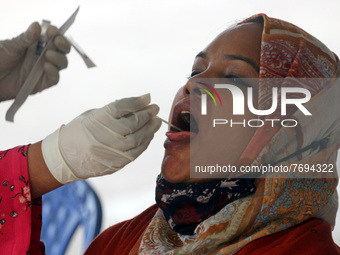 A woman, undergoes  a Polymerase Chain Reaction (PCR) test  by  swab,  to detect the COVID-19 Coronavirus disease at Mugda Medical Universit...
