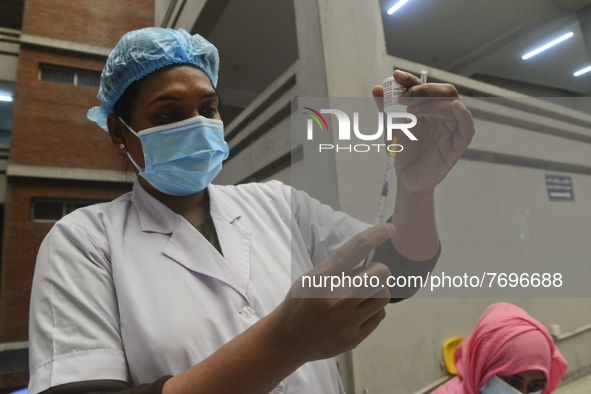 A health worker prepares to inoculate with a first dose of the Moderna COVID19 vaccine during the spread of COVID-19 coronavirus pandemic at...