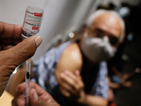 A nurse prepares a dose of Russian-made vaccine at a Coronavirus immunization site in Caracas, Venezuela on January 27, 2022. (