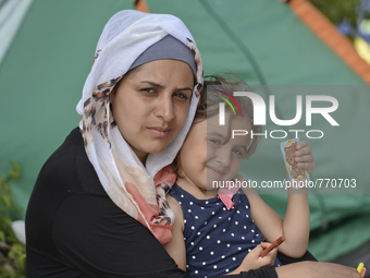 Duha, a migrant from Iraq, with her daugther Arina, in Kos Town, on the Greek island of Kos, on September 7, 2015. The head of the European...
