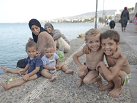 Migrants from Syria with their mothers, sitting in Kos harbor, on the Greek island of Kos, on September 7, 2015. The head of the European Un...