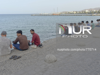 Migrants from Syria, sitting in Kos harbor, as awaiting for the boats to the main land, on September 7, 2015. The head of the European Union...
